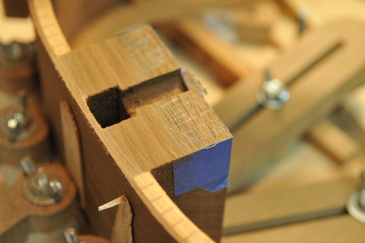 Photo showing neck block mid-way through sanding. Pencil marks gauge your progress.