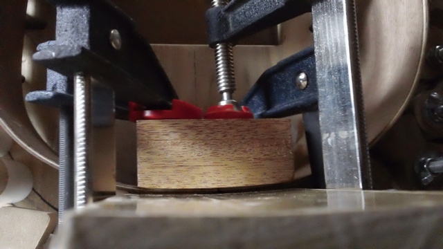 This is looking down on the headblock being glued. I round the block a bit using a radius board then use that board as a caul. I like a bit of a rounded look.