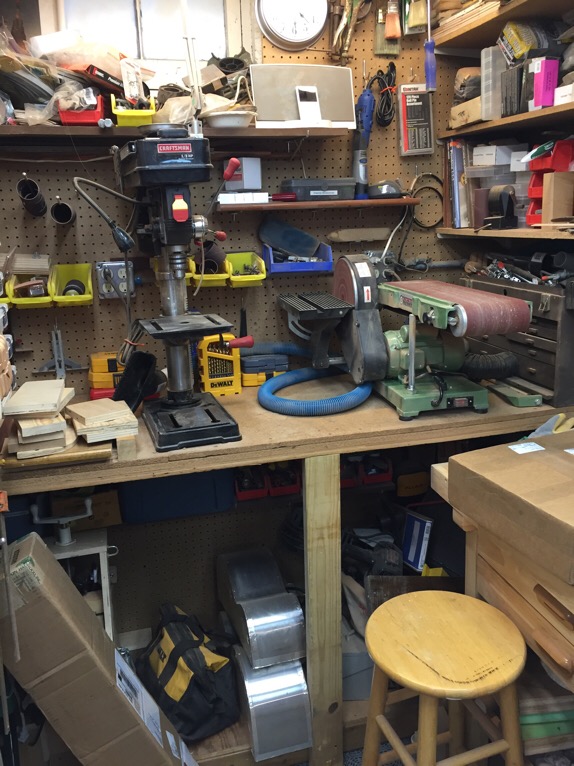 Drill press and belt sander. Storage underneath for bender.