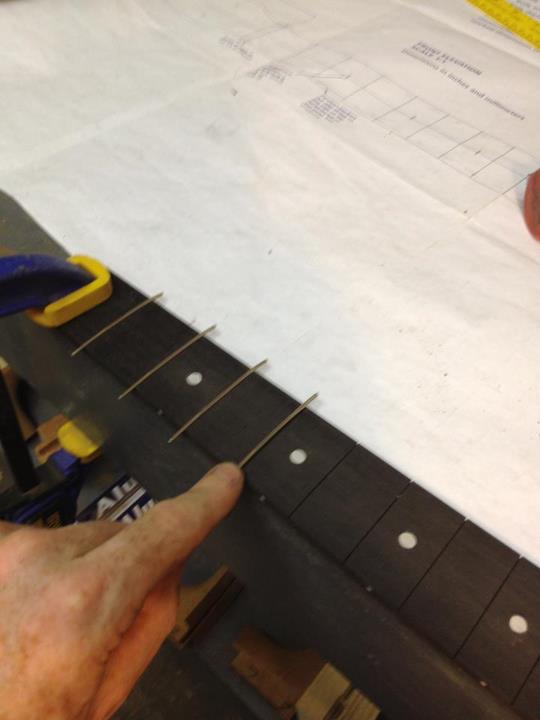 Fretting the fingerboard.