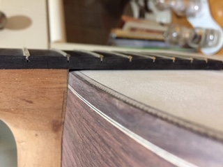 Small gap in corner of neck joint on avradiused top.